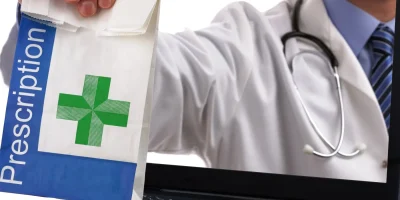 Doctor handing prescription bag through laptop screen.